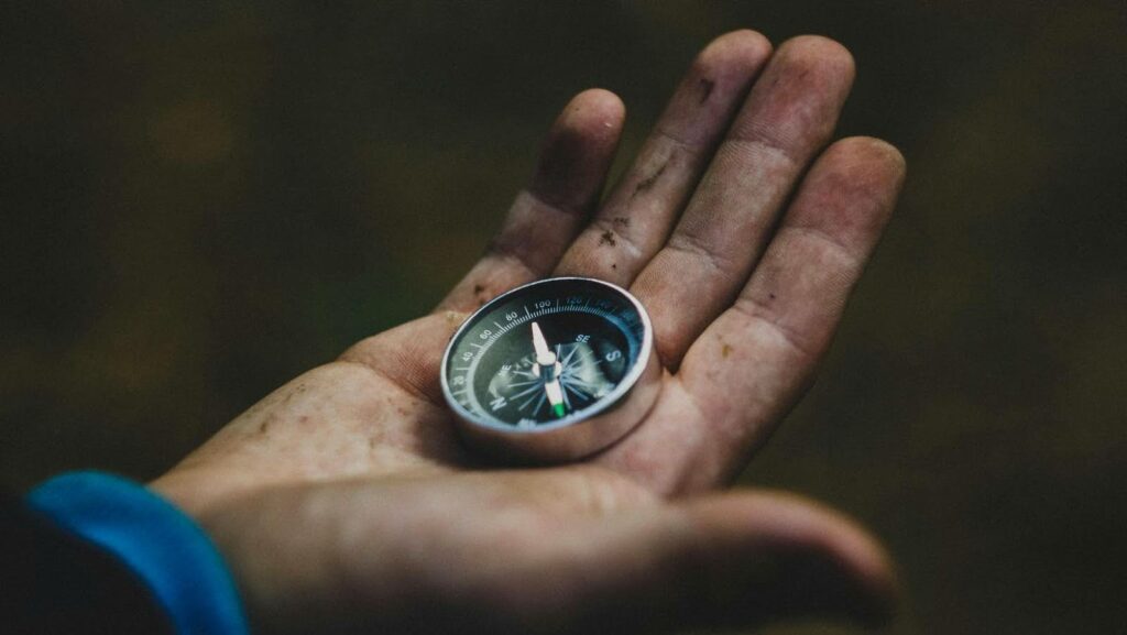 Person holding a compass