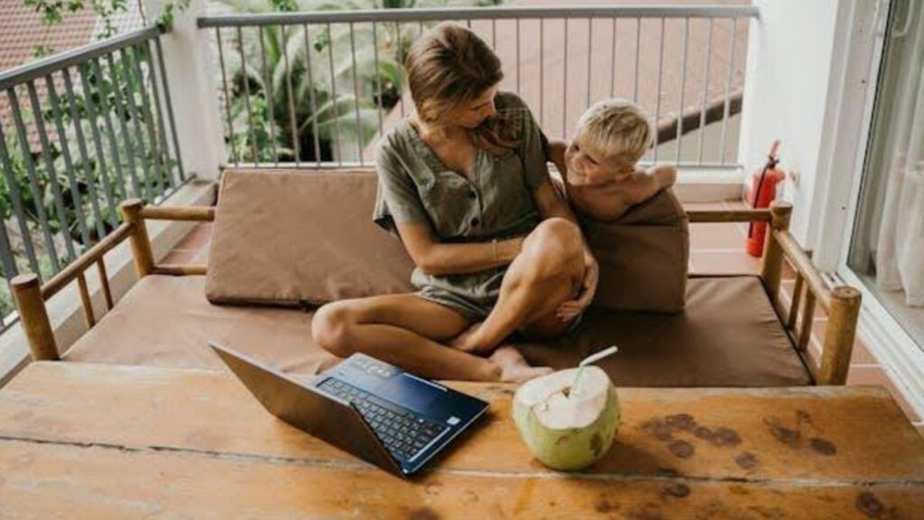 A mother and her son sitting on a sofa